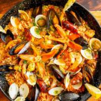 Paella · Bomba rice, shrimp, calamari, cod, clams, mussels, chicken, pork, chorizo, Saffron, fresh fa...