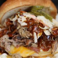 Pulled Pork · Served on a warm bun with slaw, pickles, pesto, ranch and smothered in BBQ sauce.