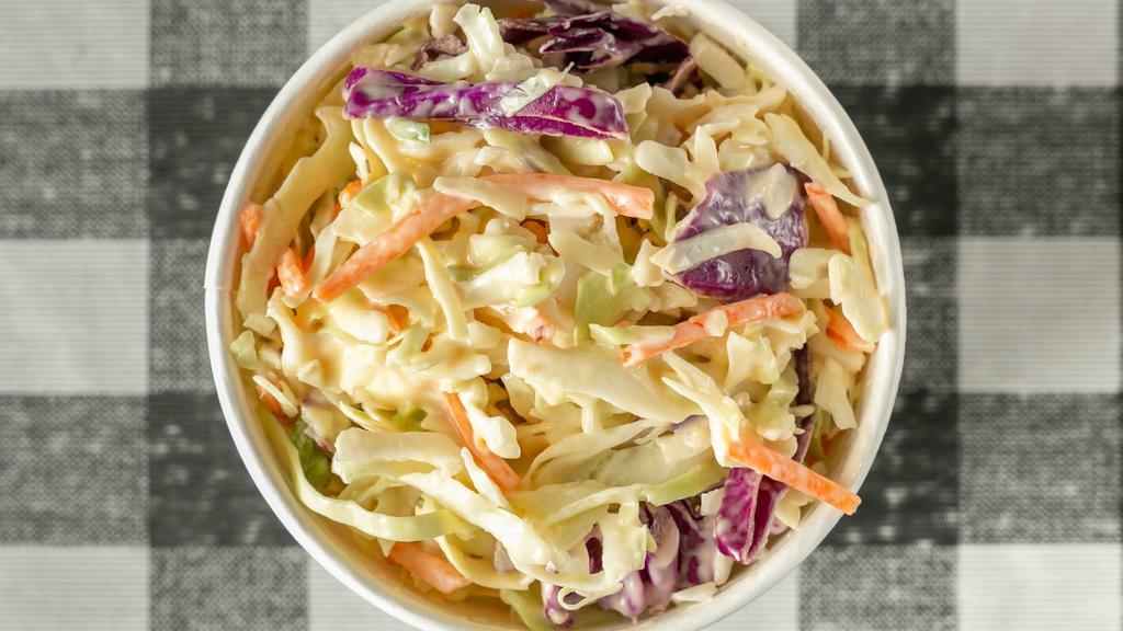 Cabbage Slaw · Shredded cabbage, carrots, and purple cabbage with house made slaw sauce