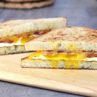 The Traditional · Baked egg white, garlic herb spread, cheddar or pepper jack, ham or bacon.