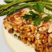 Alaskan Halibut Amandine · Almond crusted fresh Alaskan halibut, capers, beurre blanc. Served w/  asparagus and smoked ...