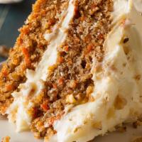 Annie'S Carrot Cake · Super moist carrot cake w/ cream cheese frosting, toasted coconut & walnuts. Served w/ caram...