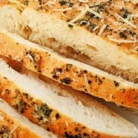 Whole Loaf Foccacia Bread · Whole Focaccia loaf baked w/ basil pesto  & parmesan