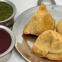 Vegetable Samosa · Veggie stuffed patties, golden fried and served with mint and tamarind chutney.