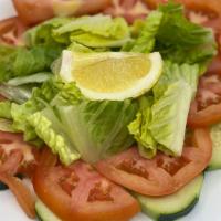 Mixed Greens Salad · Tomato, cucumber, red onion and seasonal greens toasted with lemon vinaigrette.