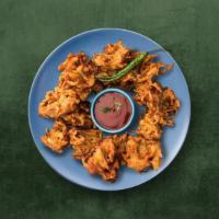 Crisp Onion Fritters · A medley of onions dipped in chickpea & rice flour batter & deep fried  till crispy and gold...