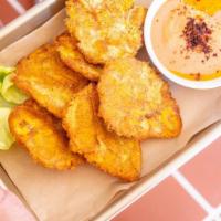 Tostones · Fried plantains, side of salsa frita