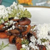 Los Maduros Vegetariano · Two fried ripe plantains topped with sauteed mushrooms, grilled scallions, recado negro, gua...