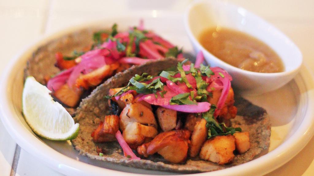 2 Adobado Tacos · Guajillo adobo chicken served on three sisters blue corn tortilla with pickled red onion, cilantro, and lime.