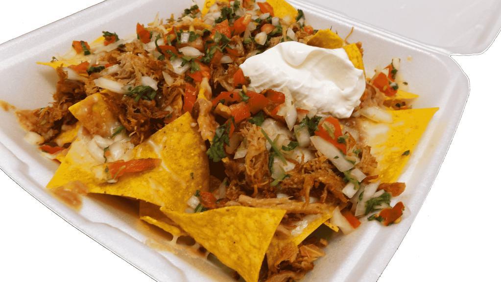 Super Nachos Plate · Crispy nachos served with melted cheese, refried beans, pico de gallo, sour cream, guacamole and your choice of meat.