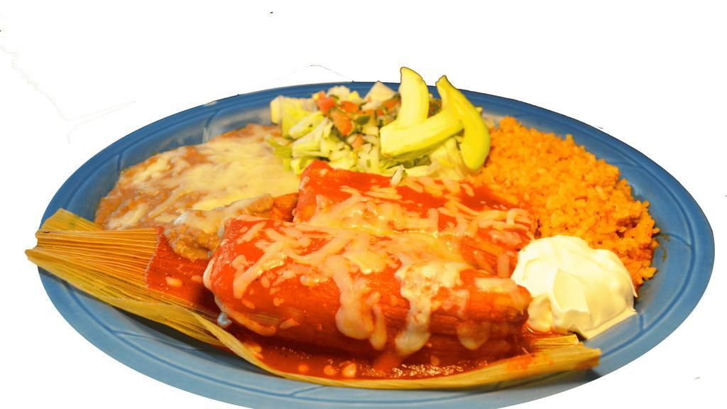 Tamales Plate · Two tamales with mild sauce, cheese, rice, refried beans, salad, sour cream and guacamole. With your choice of chicken or pork.