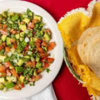 Guacamole Salad - Large · Avocado, tomatoes, onion, cilantro, jalapeño. Served with corn tortillas and salsa on the si...