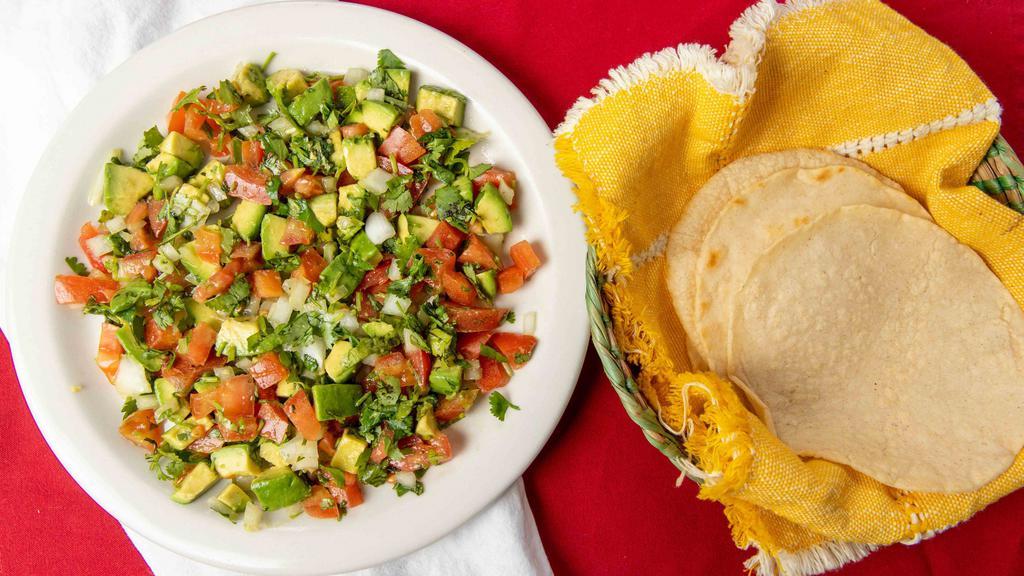 Guacamole Salad - Large · Avocado, tomatoes, onion, cilantro, jalapeño. Served with corn tortillas and salsa on the side.  Great for sharing.