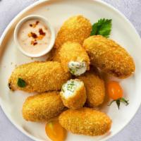 Holy Jalapeno Popper · Fresh jalapenos coated in cream cheese and fried until golden brown.