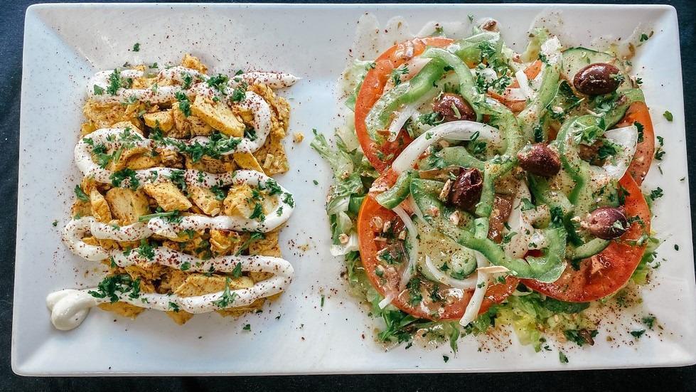 Chicken Shawarma Salad · Chicken marinated and grilled in MoMo's spices topped with garlic sauce.