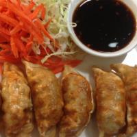 Pot Sticker · Deep-fried pork and vegetable pot stickers fried to a golden brown served with black bean sa...
