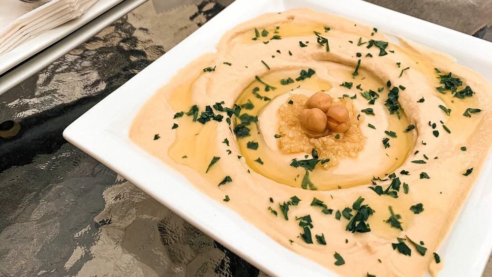 Hummus · A creamy dip of chickpeas, tahini, lemon, and garlic. Topped with olive oil