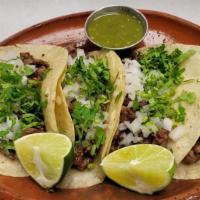 Tacos Regulares · Flour or corn tortillas, onion, and cilantro.