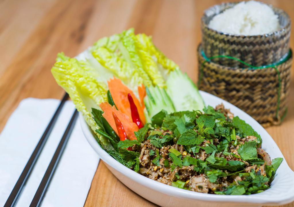E1 Larb Gai(Chicken) · A savory minced chicken seasoned with lime, chili powder, fish sauce, roasted rice powder and fresh herbs. Served with sticky rice.