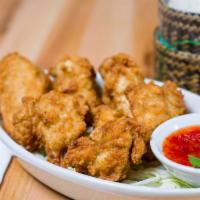 E4 Chicken Wings · Crispy fried chicken wings served with sticky rice and dipping sauce.