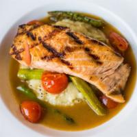 Grilled Salmon · Mashed potatoes, asparagus, thyme, cherry tomatoes, seafood consommé.
