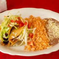 2 Hard Shell Tacos · Corn tortillas folded and filled with your choice of meat. Deep fried and topped with lettuc...