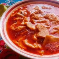 Menudo Rojo · Served with your choice of handmade tortillas or bread, and onion, cilantro and lime.