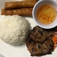 1C (Pork). Com Thit  Nuong Cha Gio · Steam rice with grilled pork and fried egg rolls.