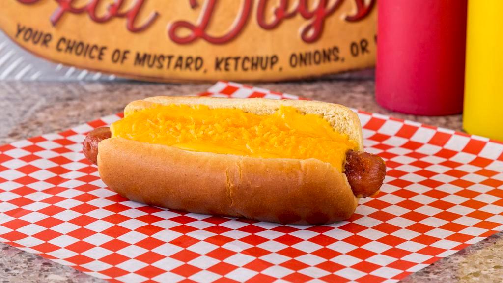 Cheese Dog · Mugsy dog loaded with cheese sauce and shredded cheddar cheese.