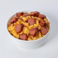 Mac N' Dogs · Mugsy dog sliced and added to our delicious mac n' cheese. Topped with cheese crackers and b...