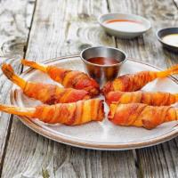 Bacon Wrapped Prawns · Our signature jumbo prawns wrapped on bacon and fried to perfection. Served with sweet chili...