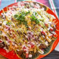 Carne Asada Fries · Fries with shredded cheese and topped with Carne Asada meat, onion, tomato, guacamole and so...
