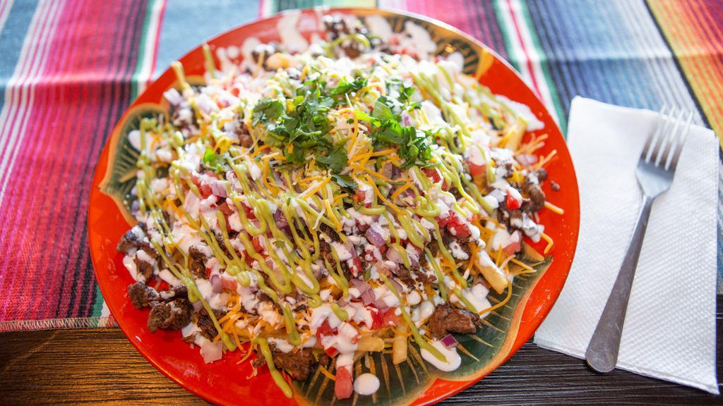 Carne Asada Fries · Fries with shredded cheese and topped with Carne Asada meat, onion, tomato, guacamole and sour cream.