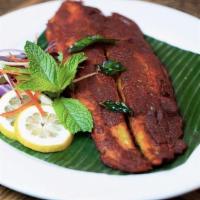 Tava Fried Fish · Spice Marinated and pan seared white fish fillets garnished with cilantro and lemon. Served ...