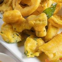 Assorted Pakoras · (VEG) Seasonal vegetables dredged in a spiced chickpea batter, golden fried and served with ...