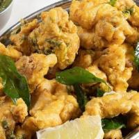 Chicken Pakoras · Golden friend chicken tenders dusted with chef's special masala blend served with cilantro d...