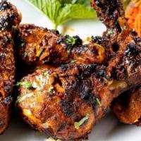 Tandoori Chicken (Bone In) · (GF) Chicken drumsticks in a classic tandoori marinade of a ginger, garlic, yogurt, garam ma...