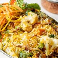 Vegetable Biryani · (GF) Hearty vegetables/meat and rice casseroles cooked with flavorful herbs & spices. Served...