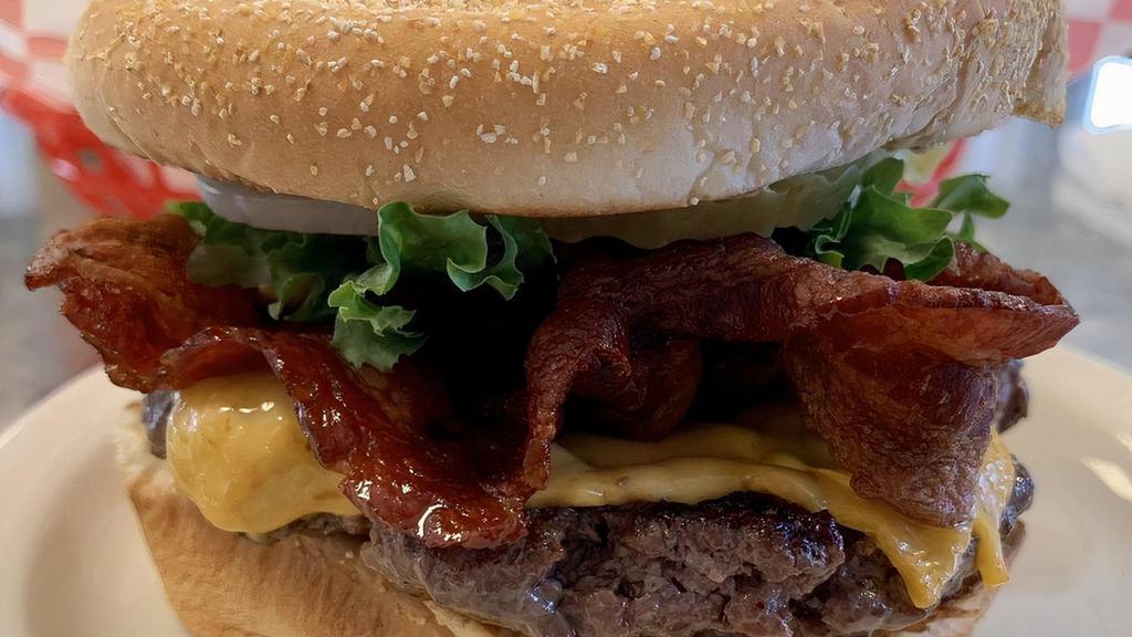 Bacon Cheeseburger · 1/3 pound burger with cheddar cheese and bacon.  Comes with ketchup, mayo, must, pickle, onion, tomato, lettuce