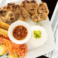 Com Ga Nuong Cha Gio · Rice with grilled chicken and eggrolls.