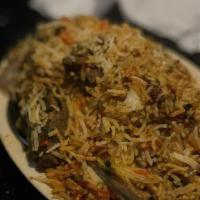 Lamb Biryani · Made with basmati rice, meat, vegetables, and an array of spices. Served with raita.