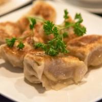 Pot Stickers 特製鍋貼 · Our own secret recipe of pork and house seasoning.