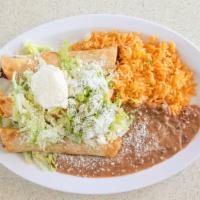Taquitos Rancheros · Three chicken taquitos with guacamole, lettuce, rice, beans, cheese, and sour cream.