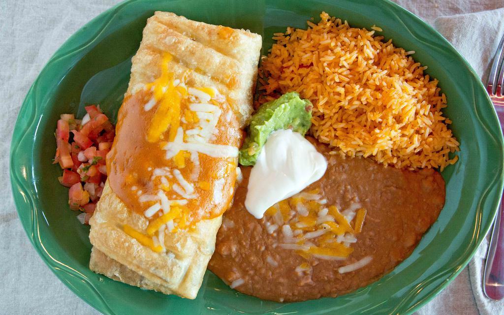 Chimichanga Carne Asada · Charbroiled bistro tender beef, cheese, pico de gallo, side enchilada sauce, sour cream, guacamole. Served with pinto or black beans, Mexican or white rice, sour cream, guacamole.