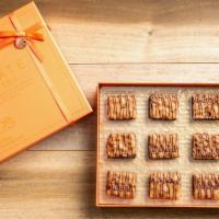 Chocolate Covered Pecan Brittle, 12 Or 24-Piece Collection · We made our small batch classic pecan brittle. Enrobbed with stribbons of milk chocolate to ...