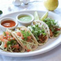 Mexican Street Tacos · Gluten free. Served on a home-made corn tortillas. Your choice of one of our meats.
