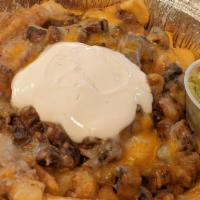 Carne Asada Fries · Gluten free. Hot french fries are loaded with melted cheese, refried beans, carne asada, Pic...