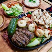 Trio Fajitas Combo (New) · Marinated steak, chicken, and shrimp fajitas served sizzling hot on a bed of sauteed onions,...