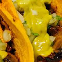 Veggie Tacos · Mushrooms marinated in adobo, topped with cilantro, onion, guacamole, pineapple. Served on a...