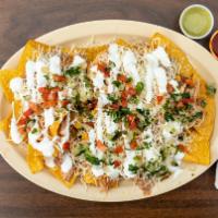 Nachos Supreme  · Corn tortilla chips with your choice of meat, topped with beans, cheese, pico de gallo and s...